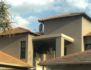 Double-storey house with terracotta tiled roofs