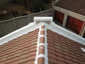 Close-up of a sealed ridge and parapet wall on a tiled roof