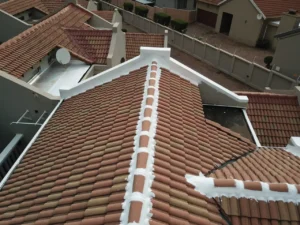 Tiled roof ridge and hips sealed with white waterproofing membrane