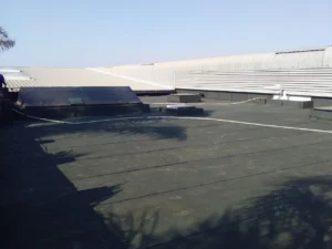 Completed torch-on waterproofing on the concrete slab roof of an industrial building
